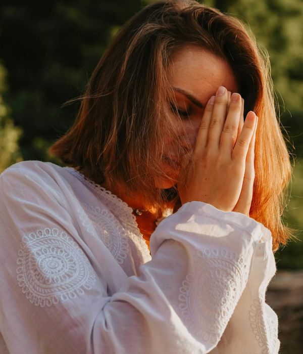 Calm woman in a serene yoga pose with eyes closed.